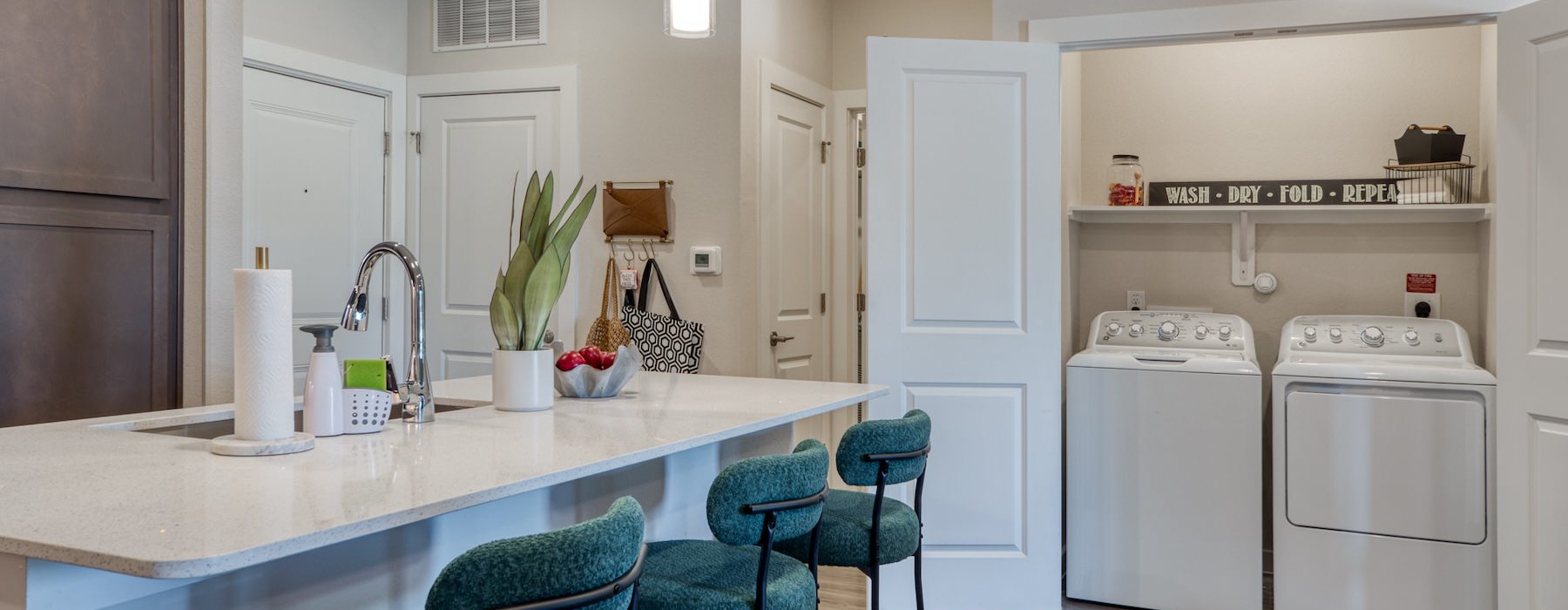 a kitchen with an island and chairs